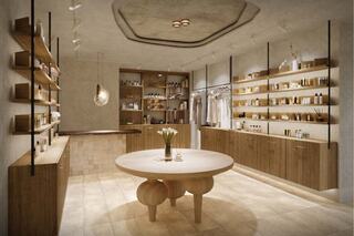 A modern, minimalist retail space featuring wooden shelves, organized products, and a round table with a bouquet, creating a calm, inviting atmosphere.