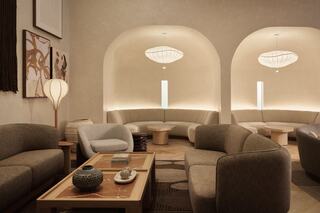 A cozy, elegant lounge featuring minimalist furniture, soft lighting, and warm tones, creating a welcoming and serene atmosphere.
