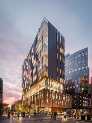 A cozy bedroom features a wooden platform bed with fluffy pillows, warm lighting, modern decor, and a minimalist design.