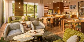 A cozy lounge area features plush seating, warm wood accents, and a buffet counter, inviting relaxation and social gatherings.