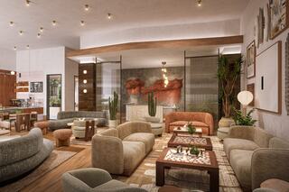 A stylish, modern lounge area featuring plush sofas, wooden accents, greenery, and warm lighting, creating an inviting atmosphere.